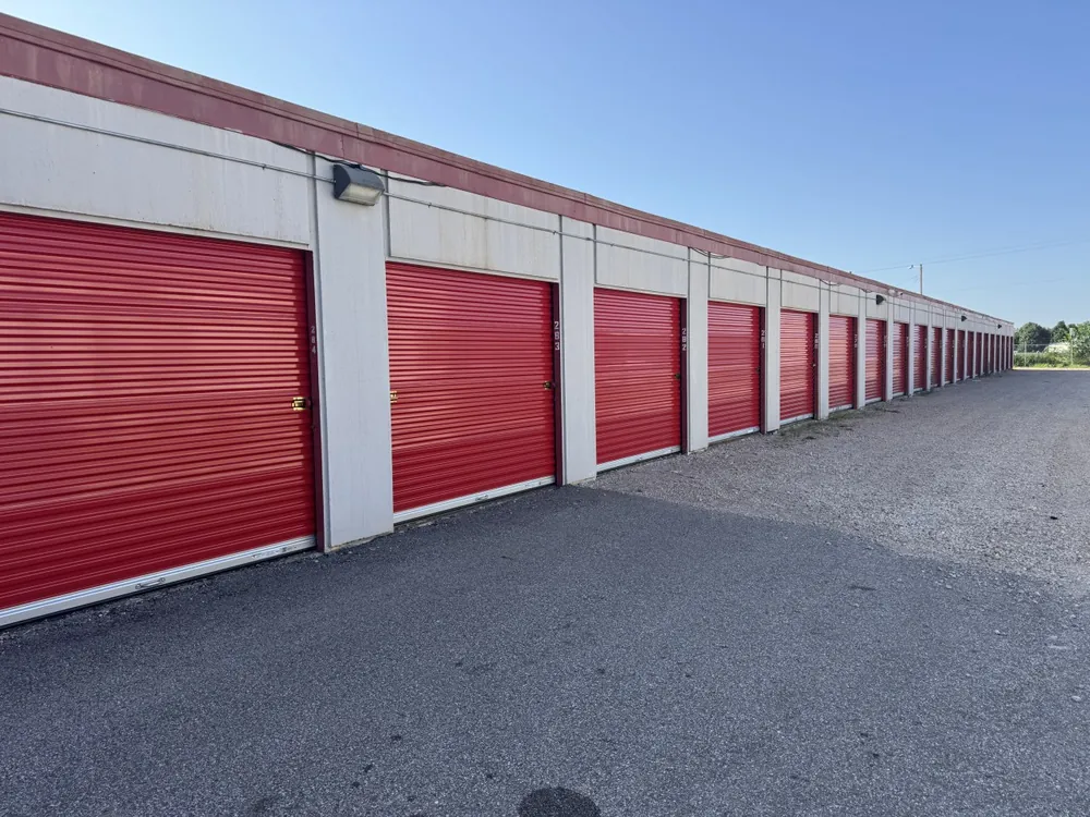 Long row of drive-up storage units along a paved aisle in Yukon, OK