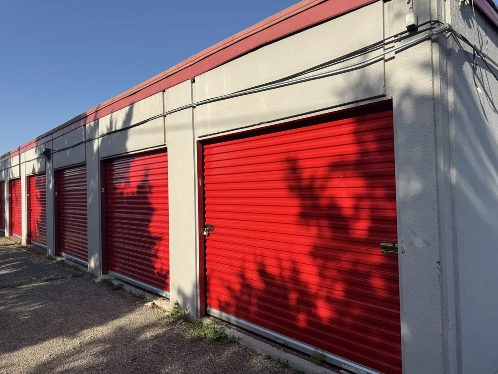 Close view of red roll-up doors on ground-floor storage units