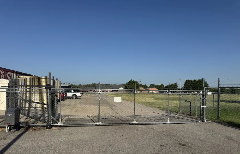 Gated chain-link entrance to the fenced storage lot at Yukon Self Storage